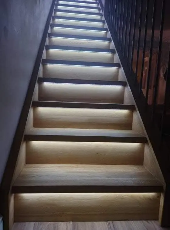Staircase with LED strip lighting under each oak tread