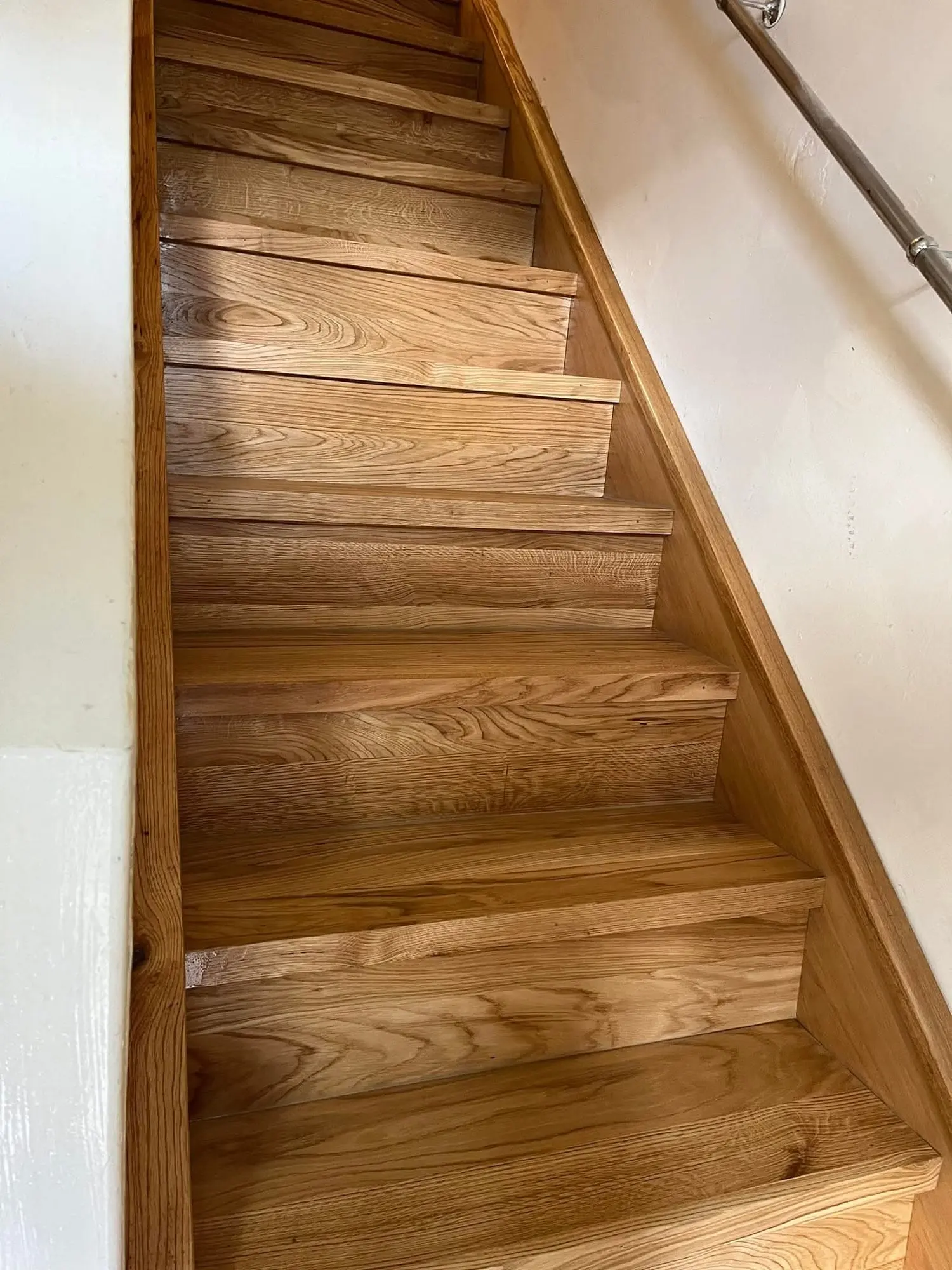Oak-clad staircase with an oak-faced string and steel handrail